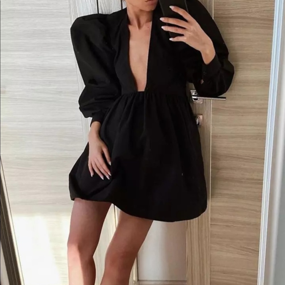 Black mini fit and flare dress with puffy sleeves and plunging neckline